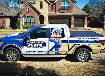 Owner Daniel is explaining to a customer what he did to service their air conditioner.